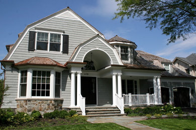 Example of a mid-sized classic gray two-story wood house exterior design in Chicago with a gambrel roof and a shingle roof