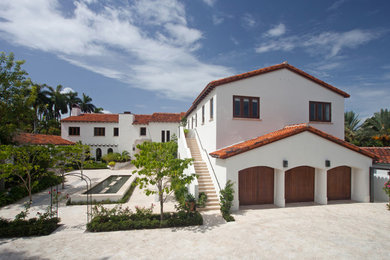 Example of a tuscan white exterior home design in Miami