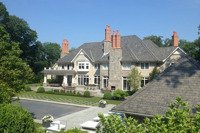 Design ideas for an expansive traditional two floor house exterior in New York with stone cladding.