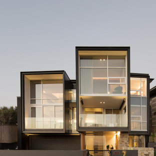 Inspiration for a contemporary three-storey house exterior in Sydney with a flat roof.