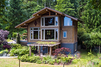 Example of a mountain style brown three-story mixed siding exterior home design in Vancouver