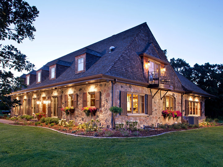 Large two-story stone exterior of a french country home