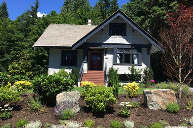 Inspiration for a large craftsman gray three-story wood gable roof remodel in Vancouver