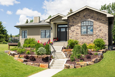Traditional brown one-story mixed siding exterior home idea in Calgary with a shingle roof