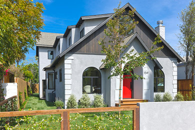Example of a mid-sized trendy gray two-story stucco exterior home design in Los Angeles