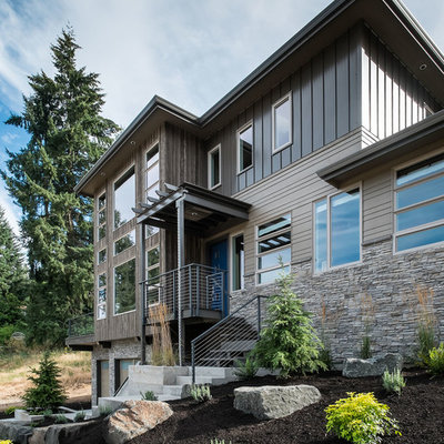 Inspiration for a large contemporary brown three-story wood exterior home remodel in Portland with a hip roof