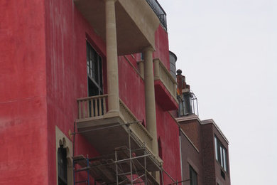 Example of a large eclectic red three-story mixed siding exterior home design in New York