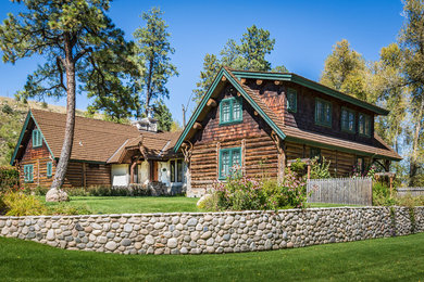 Mountain style two-story wood exterior home photo in Denver with a clipped gable roof