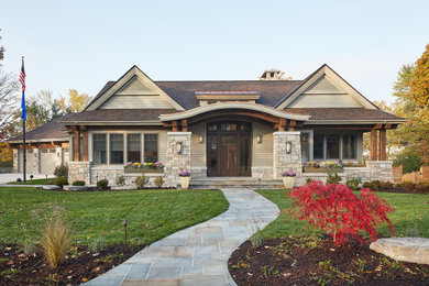 Example of a classic beige one-story concrete fiberboard exterior home design in Grand Rapids with a mixed material roof
