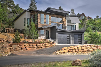 Large minimalist multicolored three-story mixed siding house exterior photo in Denver