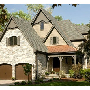 Example of a mid-sized classic beige two-story mixed siding gable roof design in Chicago