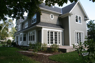 This is an example of a medium sized and gey traditional two floor house exterior in Toronto with mixed cladding.