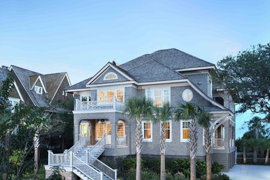 Coastal gray two-story house exterior idea in Charleston with a hip roof and a shingle roof