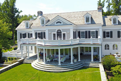 Example of a large classic three-story house exterior design in New York