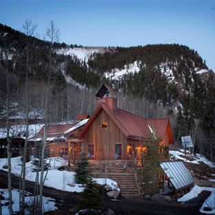 Rustic wood exterior home idea in Denver