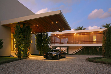 Inspiration for a large modern white wood flat roof remodel in Miami