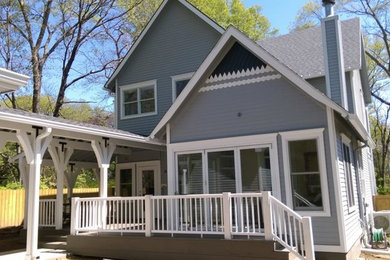 Example of a mid-sized classic gray two-story wood exterior home design in Kansas City with a shingle roof