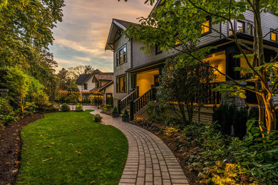 This is an example of a large and black classic detached house in Vancouver with three floors and mixed cladding.