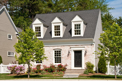 Example of a mid-sized classic white two-story brick gable roof design in Boston