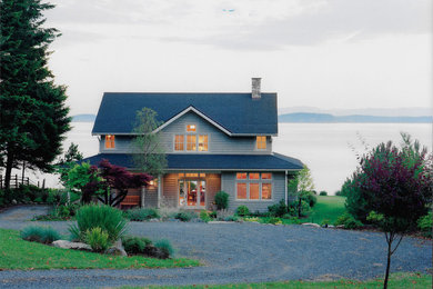 Mid-sized beach style gray two-story wood gable roof photo in Seattle