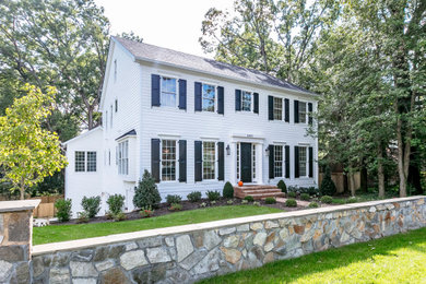 Example of a classic white two-story exterior home design in DC Metro with a shingle roof