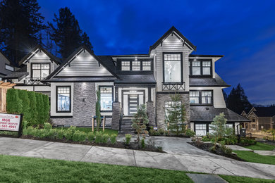 Inspiration for a large contemporary white two-story mixed siding exterior home remodel in Vancouver with a shingle roof