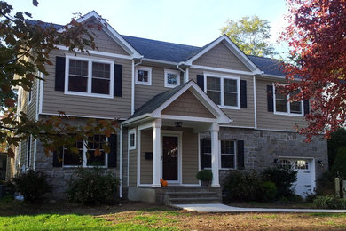 Large elegant beige two-story mixed siding gable roof photo in New York