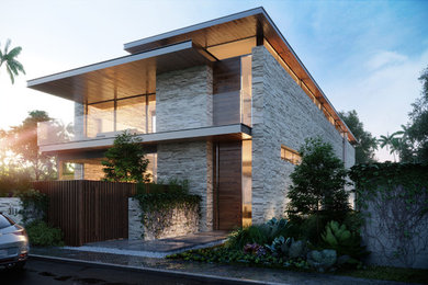 Example of a large trendy white two-story stone exterior home design in Orange County
