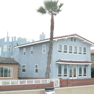 Original house with tile roof and addition with roof deck