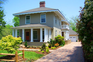 Example of a mid-sized classic beige two-story brick gable roof design in Other