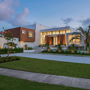 Large minimalist white two-story mixed siding exterior home photo in Tampa