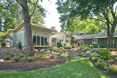 Example of a mid-sized 1960s green one-story wood exterior home design in Portland with a shed roof