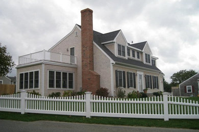 Inspiration for a large beige two-story wood exterior home remodel in Boston