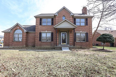 Large two-story brick exterior home photo in Louisville