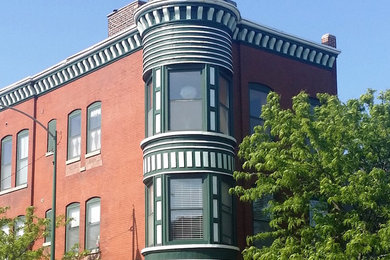 Inspiration for a large and green victorian brick house exterior in Chicago with three floors and a flat roof.