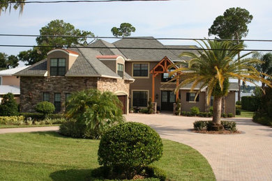 Example of a large classic brown two-story stone exterior home design in Orlando