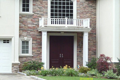 Example of a mid-sized classic white one-story stone exterior home design in New York