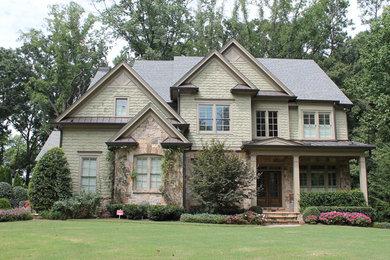 Example of a mid-sized tuscan green two-story stone exterior home design in Atlanta