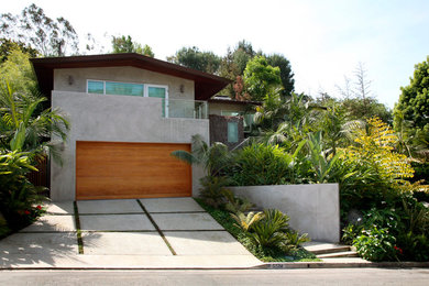 Example of a large minimalist gray two-story concrete gable roof design in Los Angeles
