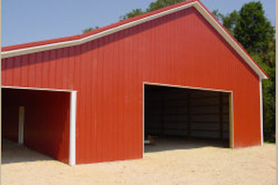 Example of a large classic red one-story metal gable roof design in Charlotte with a metal roof and a white roof
