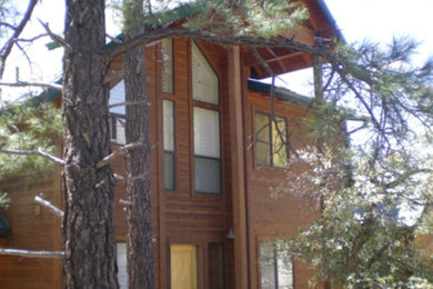 Inspiration for an expansive and brown rustic two floor detached house in Phoenix with wood cladding, a pitched roof and a green roof.