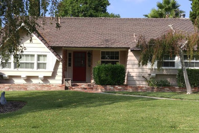 Medium sized and beige traditional bungalow detached house in Los Angeles with wood cladding, a pitched roof and a shingle roof.