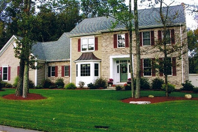 Example of a mid-sized classic beige two-story mixed siding gable roof design in New York