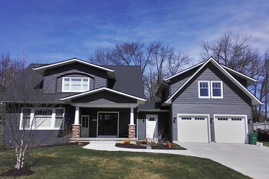 Mid-sized transitional blue two-story wood exterior home photo with a shingle roof