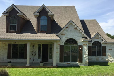 Mid-sized traditional brown two-story mixed siding exterior home idea in Austin