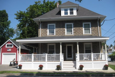 Example of a mid-sized classic brown two-story concrete house exterior design in Boston with a hip roof and a shingle roof
