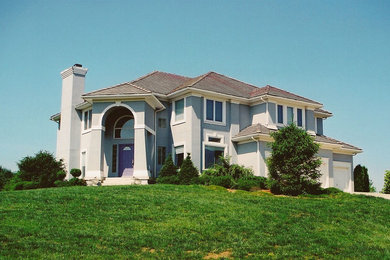 Mid-sized contemporary gray two-story stucco house exterior idea in Kansas City with a hip roof and a shingle roof