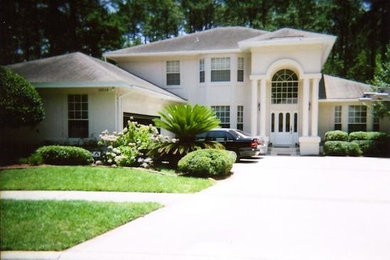 Inspiration for a large white two-story wood exterior home remodel in Jacksonville