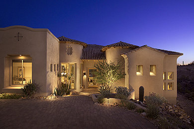Inspiration for a mid-sized southwestern beige two-story stucco exterior home remodel in Phoenix