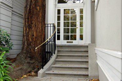 Ejemplo de fachada de casa gris clásica renovada pequeña de una planta con revestimiento de madera